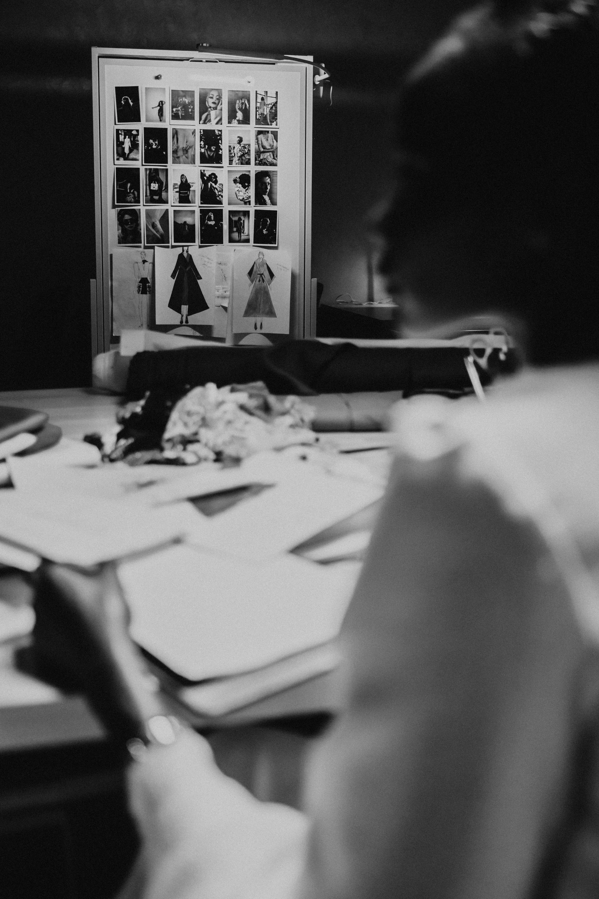 Fashion designer sketching a garment in a studio