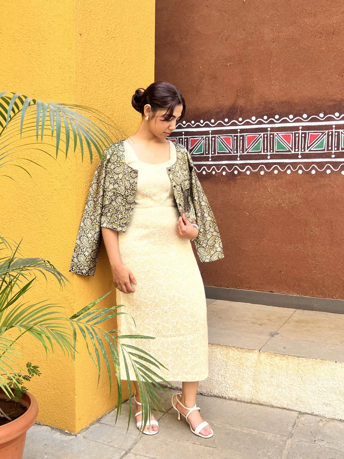 Cream dress with a cropped black and gold Himroo jacket