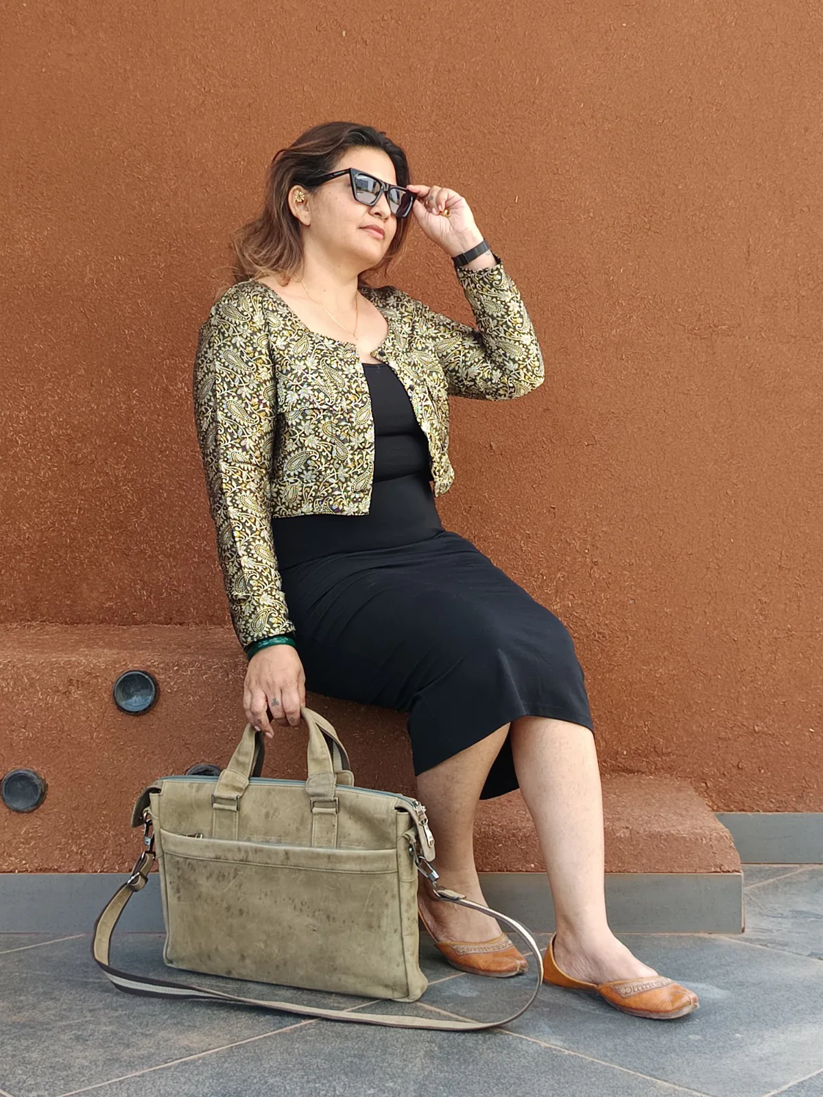 Black dress paired with a cropped Himroo jacket