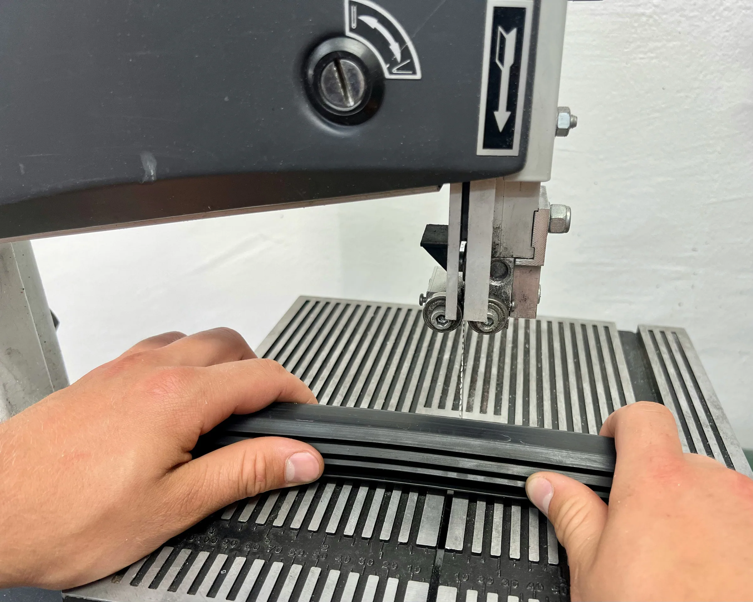 Hands guiding fabric through a sewing machine during sampling